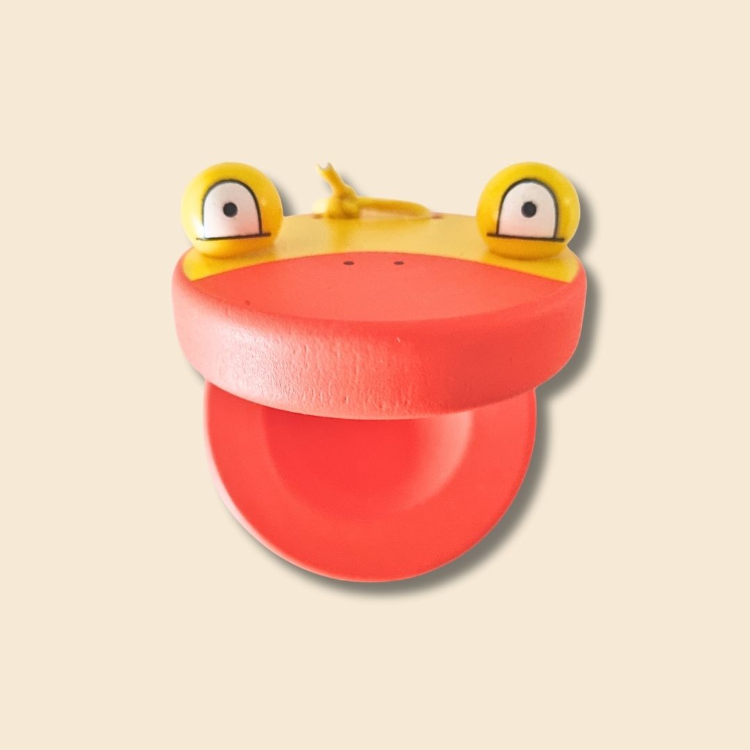 Duck shaped wooden castanet - mouth open with 3D eyes on top. Orange and yellow wooden castanet.