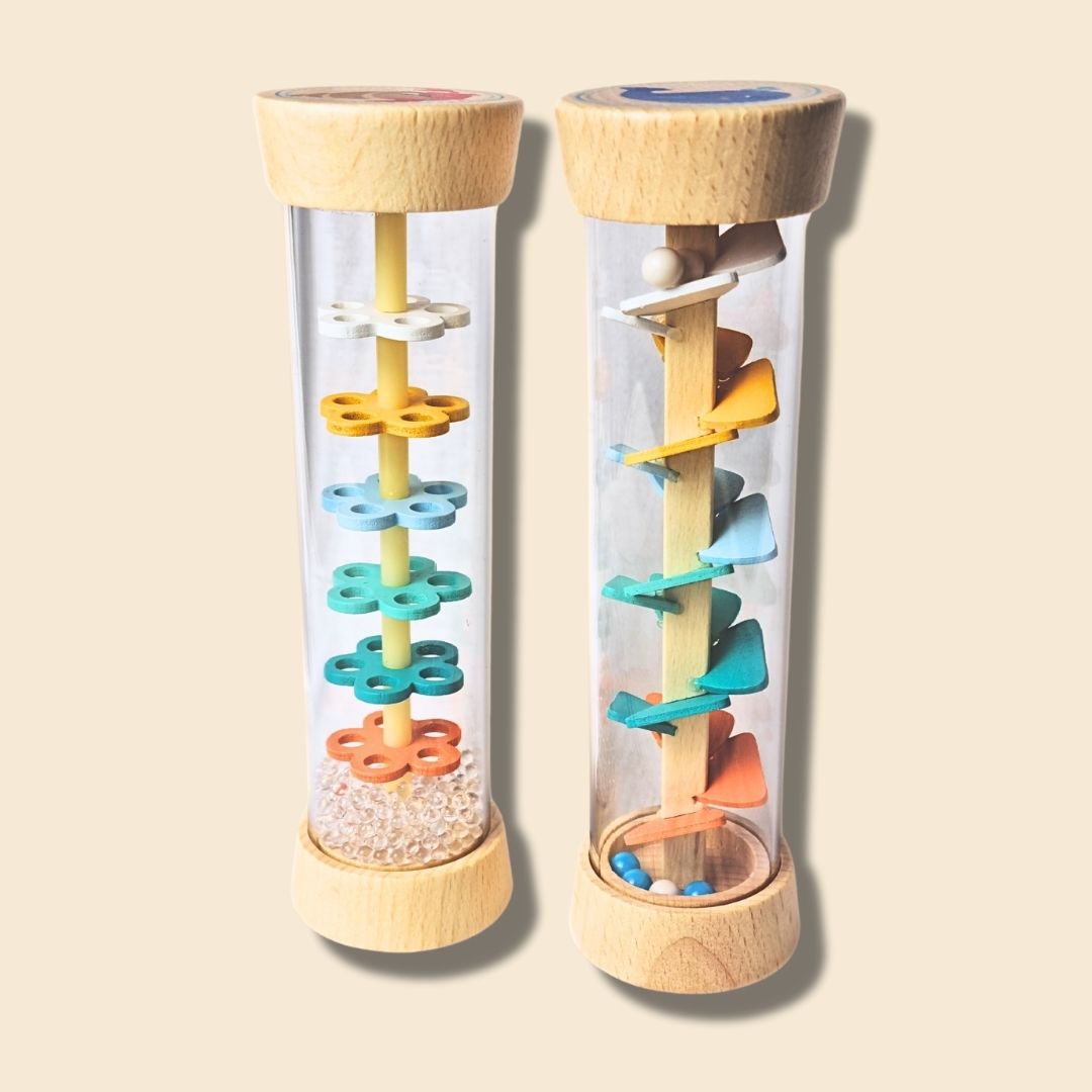 Side by Side comparison of the two Wooden Rainstick variants on a beige background