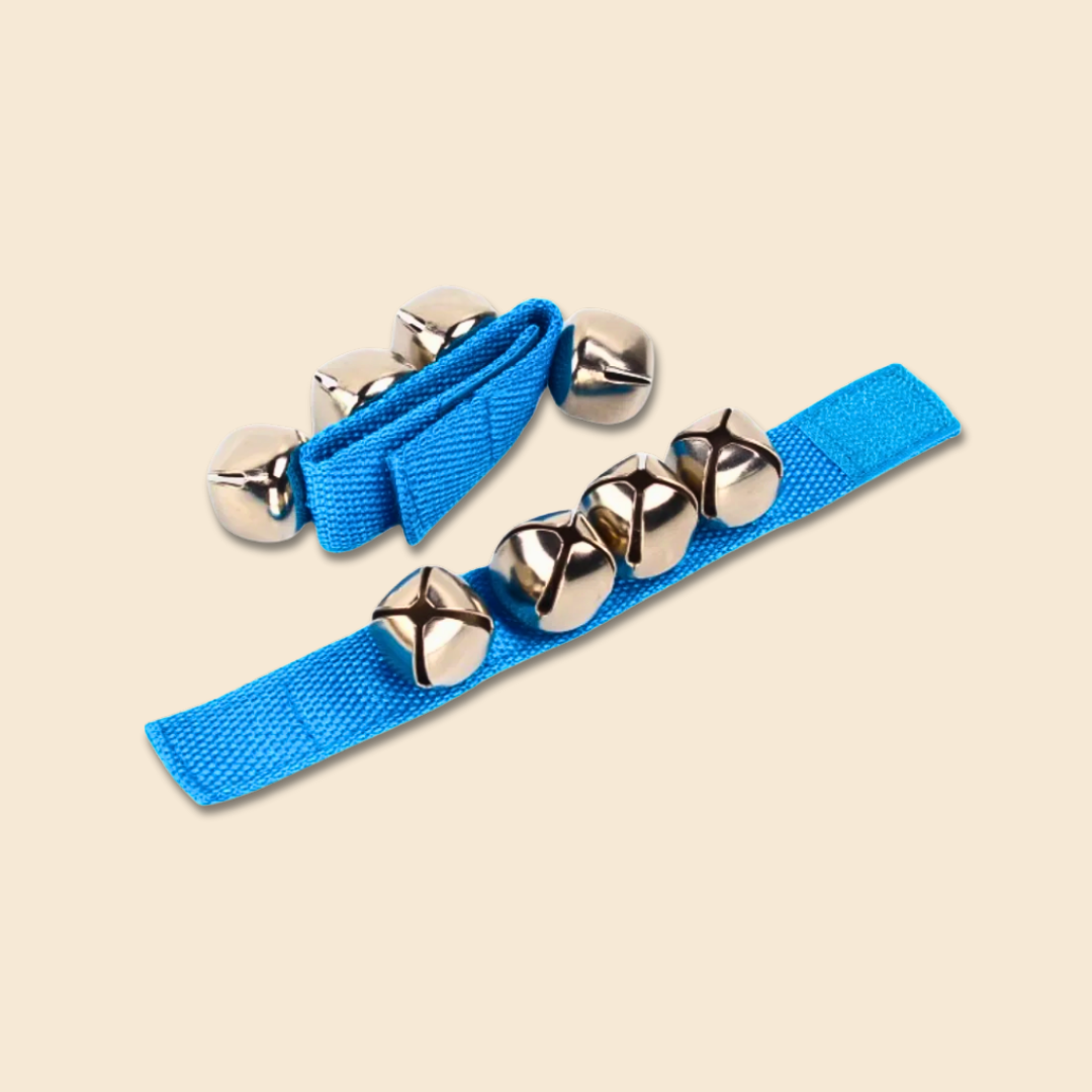 Two blue jingle bell straps with silver bells on a beige background