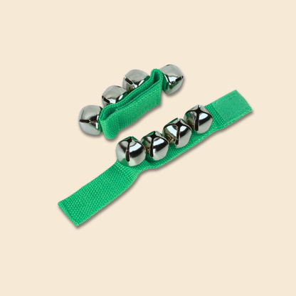 Green jingle bell straps on a beige background