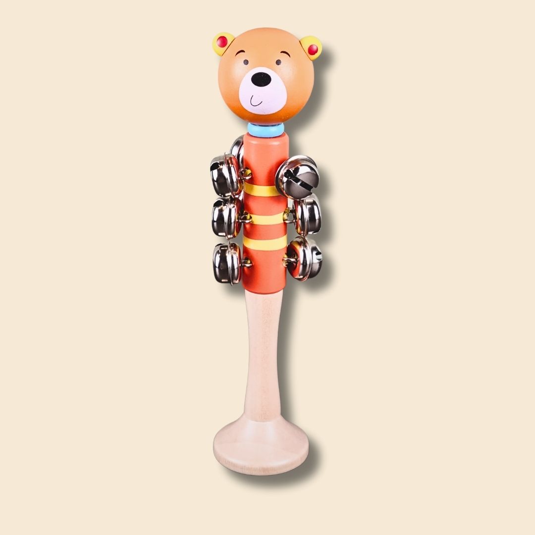 orange bear wooden bell stick music instrument for kids on a beige background