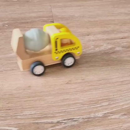 Wooden Toy Pullback Cement truck in action zoomed across wooden floors